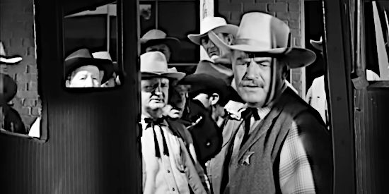 Ray Teal as Sheriff Riorden, checking the inside of a stagecoach involved in a robbery in The Phantom Stagecoach (1957)