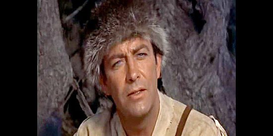 Robert Taylor as Bushrod Gentry, the trapper determined not to be trapped into settling down in Many Rivers to Cross (1955)