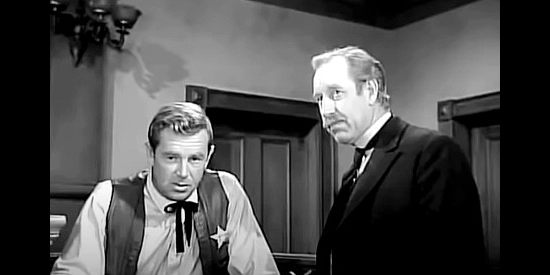 Sterling Hayden as Sheriff Galt, under questioning by District Attorney Holloway (Frank Ferguson) in The Iron Sheriff (1957)