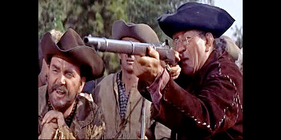 Victor McLaglen as Cadmus Cherne, in a shooting match with rival Lige Blake (Rhys Williams, left) in Many Rivers to Cross (1955)