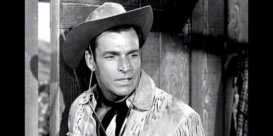 Buster Crabbe as Chad Santee, his dreams of a lawful reunion with his brother shattered in Gun Brothers (1956)