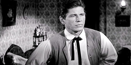 Charles Bronson as Luke Welch, determined to collect the $200 bounty he's owed in Showdown at Boot Hill (1958)
