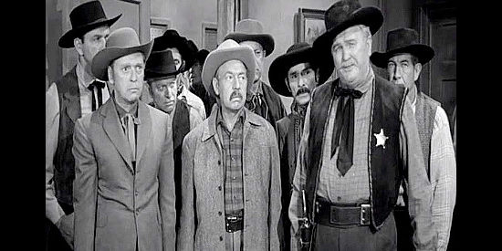 Charles Cane (right) as Sheriff Claude Mundy, wondering why the saloon owner is dead in his office in Gun Battle at Monterey (1957)