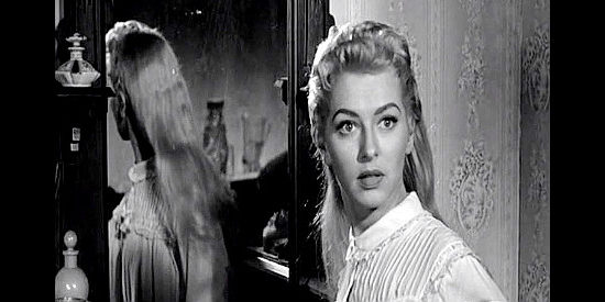 Dani Crayne as Nell Garrison, startled by an unexpected visitor in Shoot-out at Medicine Bend (1957)