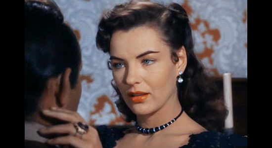 Ella Raines as Nan Morgan, using her charm to try to learn the location of Rhiannon's hidden loot in Singing Guns (1950)
