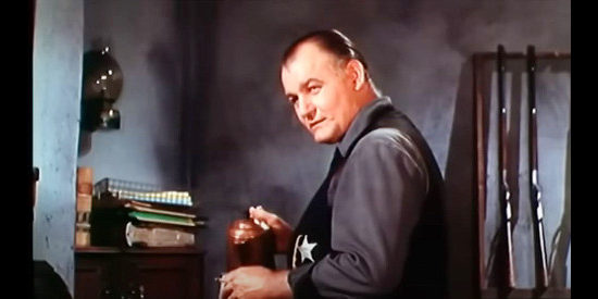 Emile Meyer as Nat Bell, sheriff in a town ruled by Josiah Bannerman in Stranger on Horseback (1955)