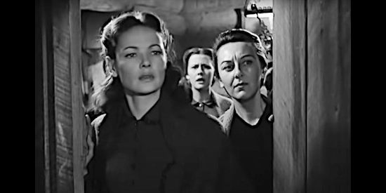 Gene Tierney as Marcia and Ann Dvorak as Rachel Schaeffer, watching strangers approach in The Secret of Convict Lake (1951)