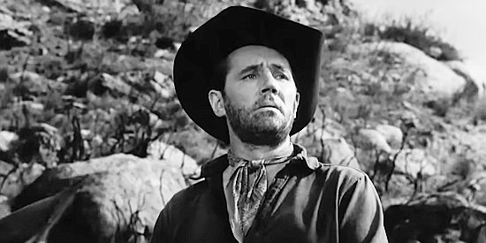 Howard Duff as Jess Collins, spotting two men beating up a third as he approaches the town of Colton in Sierra Stranger (1957)