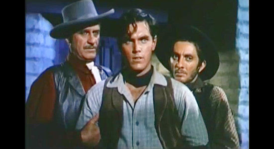 Jeffrey Hunter as Johnny Colt, in the hands of Apache Joe gang members McAdoo (Frank Wilcox) and Catur (Aaron Spelling) in Three Young Texans (1954)