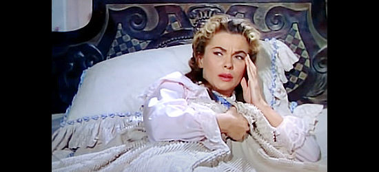 Joanne Dru as Nora Curtis, dealing with a hangover and fears of what might have happened while she was drunk in The Siege at Red River (1954)