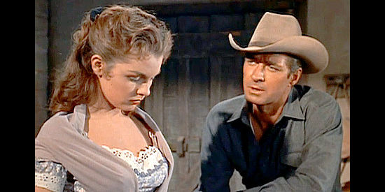 Jock Mahoney as Joe Dakota, getting Jody Weaver (Luana Patten) to share a difficult memory in Joe Dakota (1957)