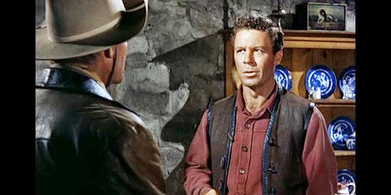 John Archer as Clint Canfield, listening to concerns from brother Britt in Sante Fe (1951)