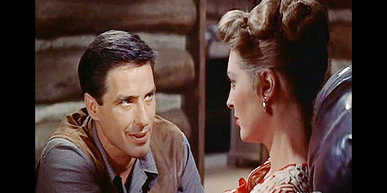 John Cassavetes as Steve Sinclair, trying to make sure Joan Blake (Julie London) is comfortable in her new home in Saddle the Wind (1958)