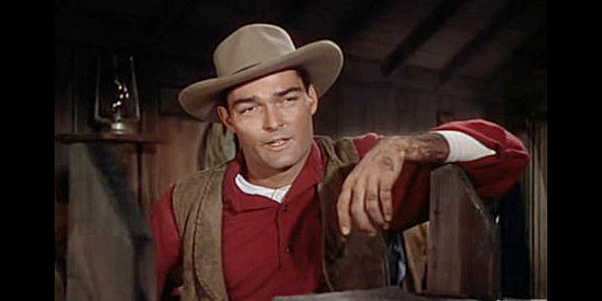 John Russell as Rocky, foreman for Jess Higgins, laying down some rules for new ranch hand Chuck Conner in Saddle Tramp (1950)