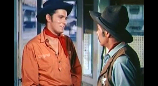Keefe Brasselle as Tony Ballew, questioned by the sheriff after spending stolen loot on a new $20 shirt in Three Young Texans (1954)