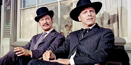 Kenneth Tobey as Bat Masterson and Burt Lancaster as Wyatt Earp, watching a beauty arrive in town in Gunfight at the O.K. Corral (1957)