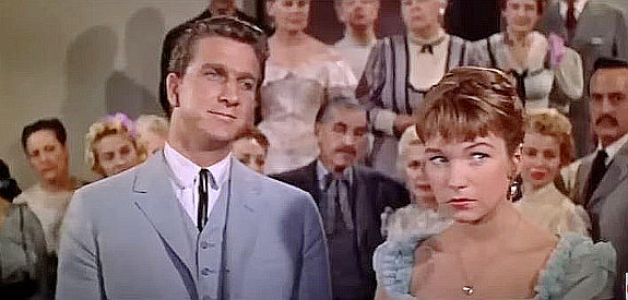 Leslie Nielson as Col. Stephen Bedford and Shirley MacLaine as his fiance, pulling a fast one on Jason Sweet in The Sheepman (1958)
