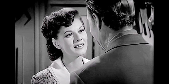 Lorna Gray (Adrian Booth) as Livvy Weston, enjoying a reunion with John Baker (Steve McKay) in The Savage Horde (1950)