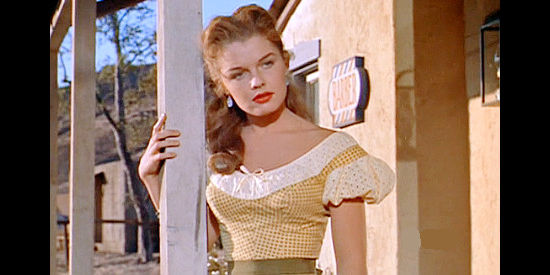 Luana Patten as Jody Weaver, meeting Joe Dakota as he arrives in Aborville in Joe Dakota (1957)