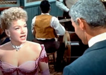 Anne Baxter as Cherry Malotte and Jeff Chandler as Roy Glennister in The Spoilers (1956)