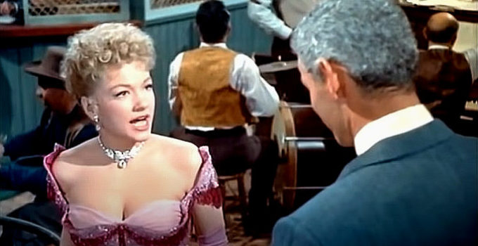 Anne Baxter as Cherry Malotte and Jeff Chandler as Roy Glennister in The Spoilers (1956)