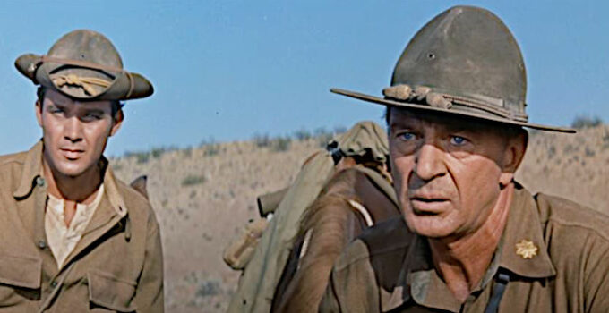 Gary Cooper as Maj. Thomas Thorn, watching the U.S. cavalry attack at the Geary ranch as Pvt. Andrew Hetherington (Mihcale Callan) looks on in They Came to Cordura (1959)