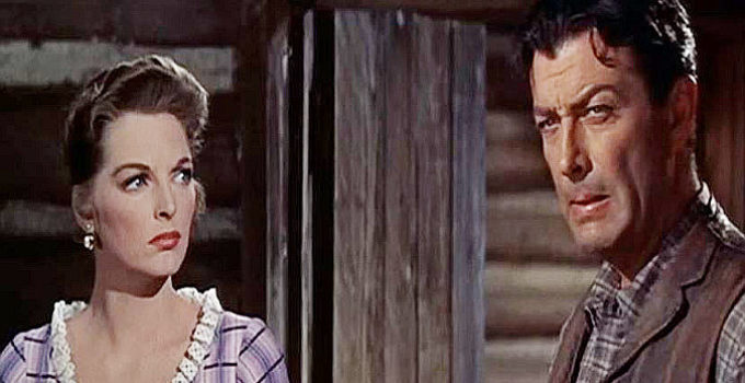 Julie London as Joan Blake and Robert Taylor as Steve Sinclair in Saddle the Wind (1958)