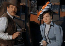 Ward Bond as Sheriff Jim Caradac and Ella Raines as Nan Morgan during a stage holdup in Singing Guns (1950)