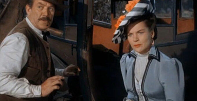 Ward Bond as Sheriff Jim Caradac and Ella Raines as Nan Morgan during a stage holdup in Singing Guns (1950)