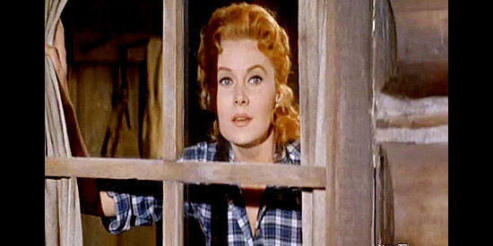 Rhonda Fleming as Jo, watching hopefully for the return of Tom Earley as complications mount in Gun Glory (1957)