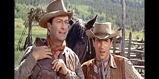 Robert Taylor as Steve Sinclair and John Cassavetes as yonger brother Tony after the latter brings pretty Joan Blake to the ranch in Saddle the Wind (1958)