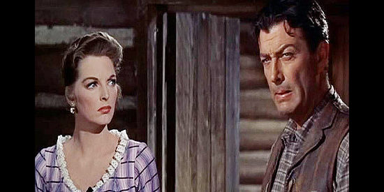 Robert Taylor as Steve Sinclair, wondering if he can save his gun-happy younger brother while Joan Blake (Julie London) looks on in Saddle the Wind (1958)