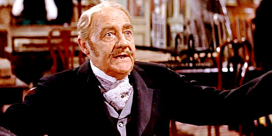 Ronald Squire as Toynbee, explaining the financial problems faced by the Tibbs' gun business in The Sheriff of Fractured Jaw (1958)