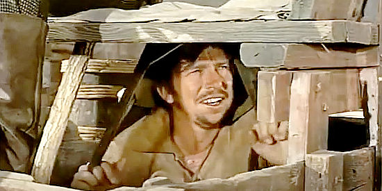 Slim Pickens as Sam Beekman, hiding in a wagon to surprise warring Indians in Sante Fe Passage (1955)