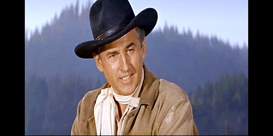 Stewart Granger as Tom Earley, a gunman who returns home after a long absence and has to win back the affection of his son in Gun Glory (1957)