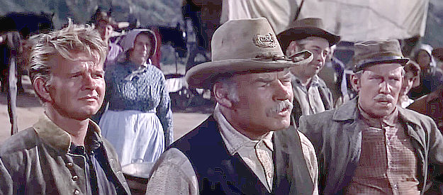 The wagon train members, including Cap (Ray Teal) question Ned Bannon in The Tall Stranger (1957)