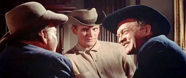 Van Heflin as Lee Hackett, talking to the man who testifyed for his son while Ed Hackett (Tab Hunter) looks on in Gunman's Walk (1958)