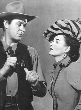 Vaughn Monroe as Rhiannon and Ella Raines as Nan Moran in Singing Guns (1950)