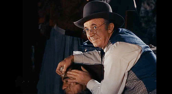 Walter Brennan as Dr. Jonathan Mark, happily watching Rhiannon play the role of hero in Singing Guns (1950)