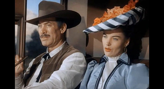 Ward Bond as Sheriff Jim Caradac and Ella Raines as Nan Morgan, bonding over the unwelcome advances of a traveling salesman in Singing Guns (1950)
