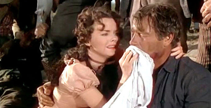 Wanda Hendrix as Della rushing to the aid of Chuck Conner (Joel McCrea) following a fight in Saddle Tramp (1950)