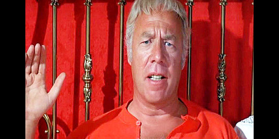 George Kennedy as Hoke Birdsill, pledging to preserve the law as the new sheriff of Yearkey’s Hole in Dirty Dingus Magee (1970)