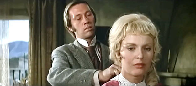 David Carradine as David Mountford, trying to undo his new wife's dress with one hand in Macho Callahan (1970)