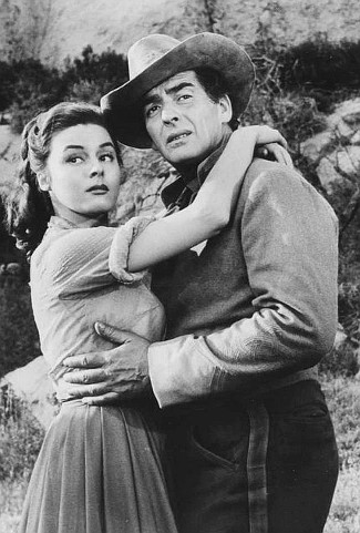 Elaine Stewart as Beth Drury and Victor Mature as Ben Lassiter in Escort West (1959)