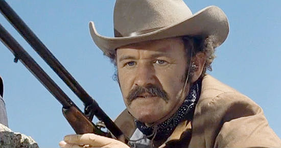 Gene Hackman as Brandt Ruger with the long-range rifle after getting his first taste of human blood in The Hunting Party (1971)