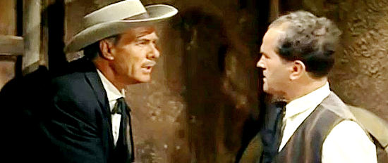 George Riguad as saloon owner Jim Bailey frets with his bartender (Antonio Moreno) over the stranger in Tombstone in Ringo's Big Night (1965)