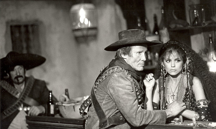 Henry Silva as Bernardo and gina Gallego as Ninfa in Lust in the Dust (1985)