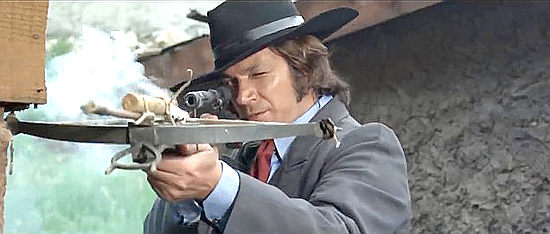 Jeff Cameron as Alan Boyd with his crossbow and a stick of dynamite in Bounty Killer for Trinity (1972)