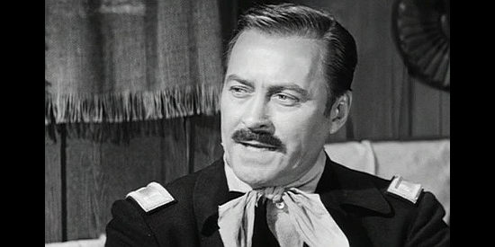 John Hubbard as Lt. Weeks, commander of the patrol Beth and Martha Drury are traveling with in Escort West (1959)