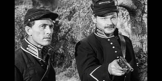 Ken Curtis as Trooper Burch and Leo Gordon as Trooper Vogel, demanding an Army payroll from Lassiter in Escort West (1959)